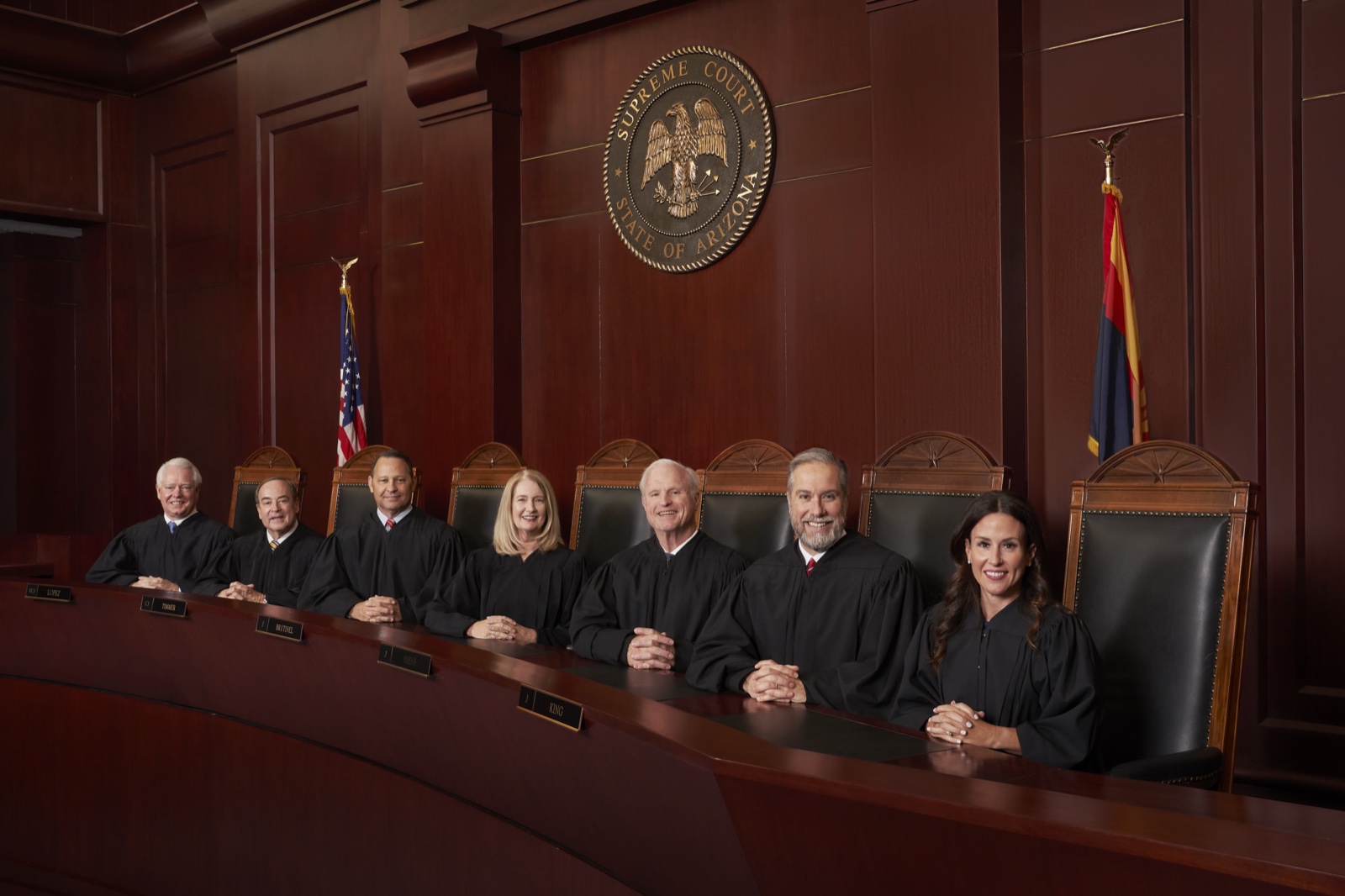 The seven justices of the Arizona Supreme Court seated behind the court's bench.