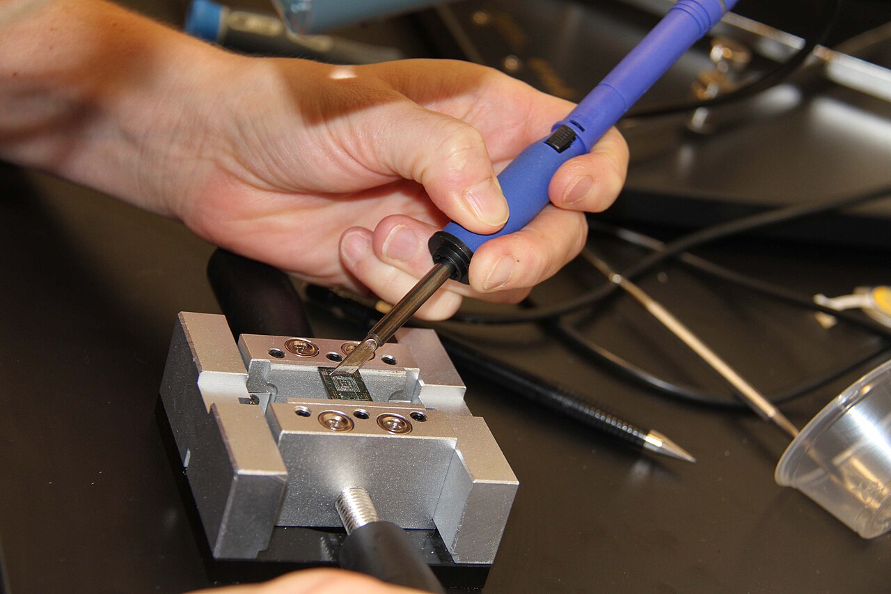 A U.S. Diplomatic Security Service forensic examiner works with a mobile device.